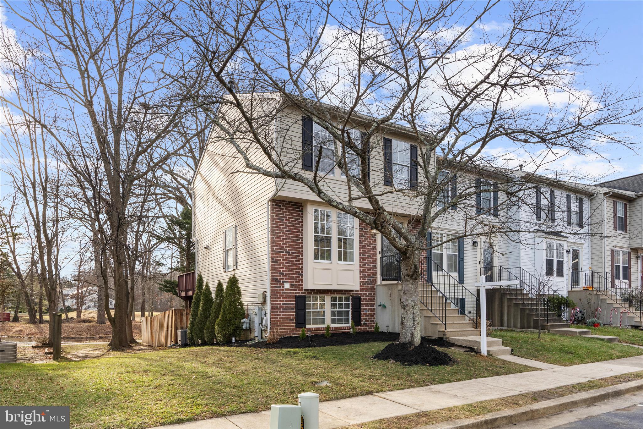 1530 Falstone Lane Crofton, MD 21114 - Photo 3 of 53 a large tree in front of a brick house