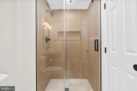 a bathroom with a shower and a sink