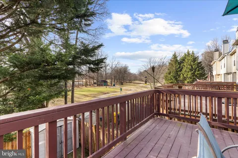 a view of balcony with wooden floor and fence