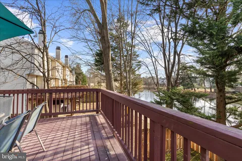 a view of balcony with wooden floor and fence and floor