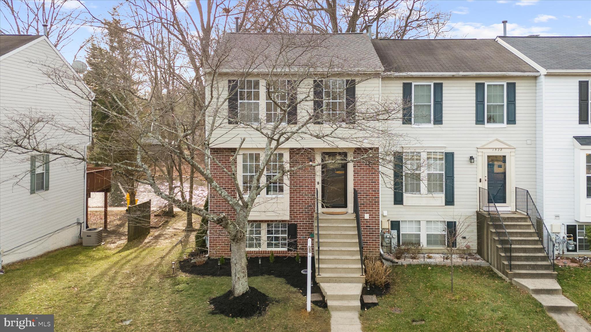 1530 Falstone Lane Crofton, MD 21114 - Photo 4 of 53 a front view of a house with a yard