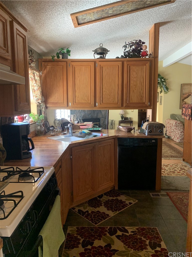 29043 Paradise Road Val Verde, CA 91384 - Photo 11 of 23 a kitchen with a stove a sink and a window