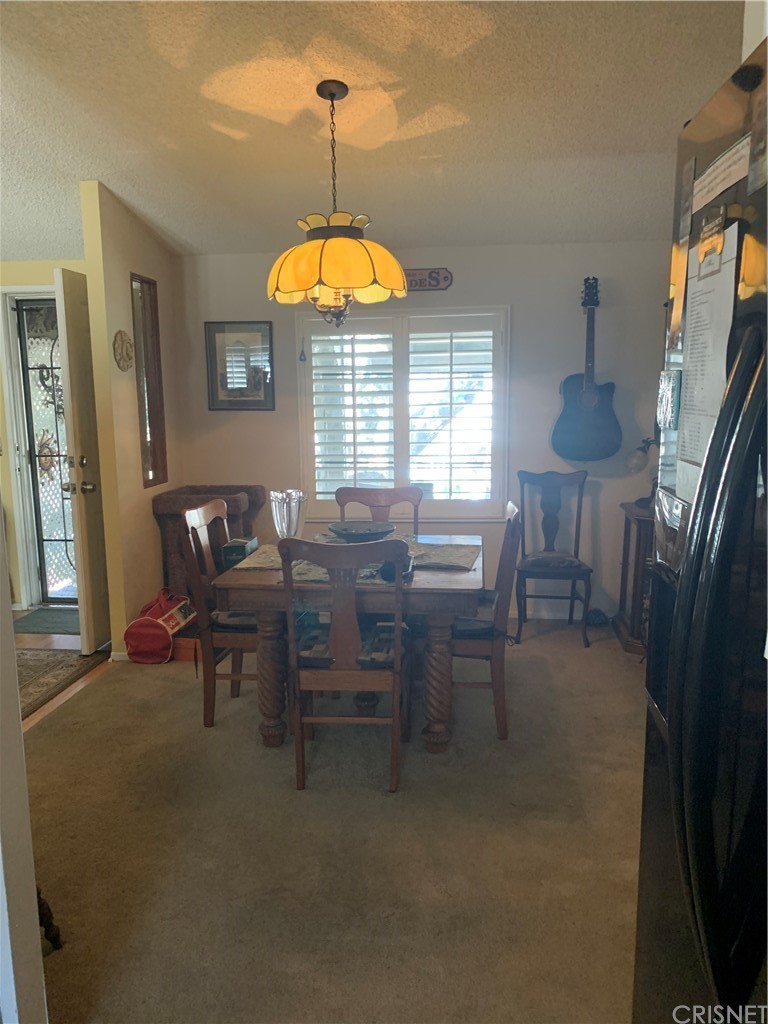 29043 Paradise Road Val Verde, CA 91384 - Photo 12 of 23 a view of a dining room with furniture and chandelier