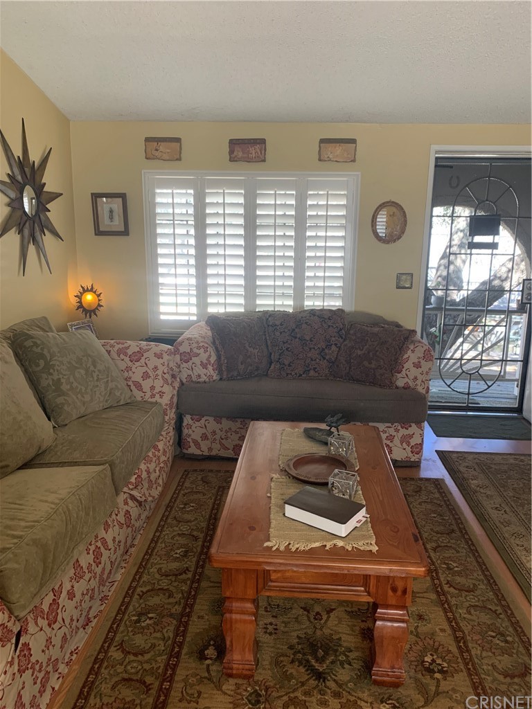 29043 Paradise Road Val Verde, CA 91384 - Photo 13 of 23 a living room with a couch and a window