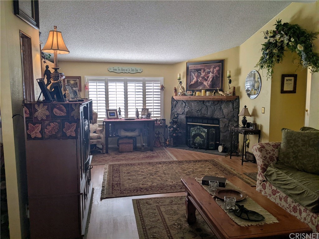 29043 Paradise Road Val Verde, CA 91384 - Photo 15 of 23 a living room with furniture and a fireplace
