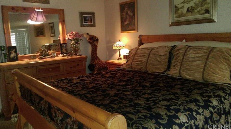 29043 Paradise Road Val Verde, CA 91384 - Photo 17 of 23 a bed sitting in a bedroom next to a bathroom