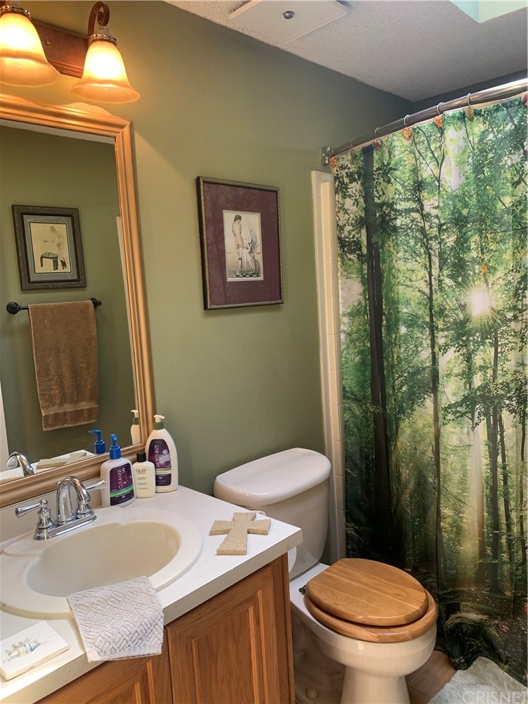 29043 Paradise Road Val Verde, CA 91384 - Photo 19 of 23 a bathroom with a granite countertop sink mirror vanity and toilet