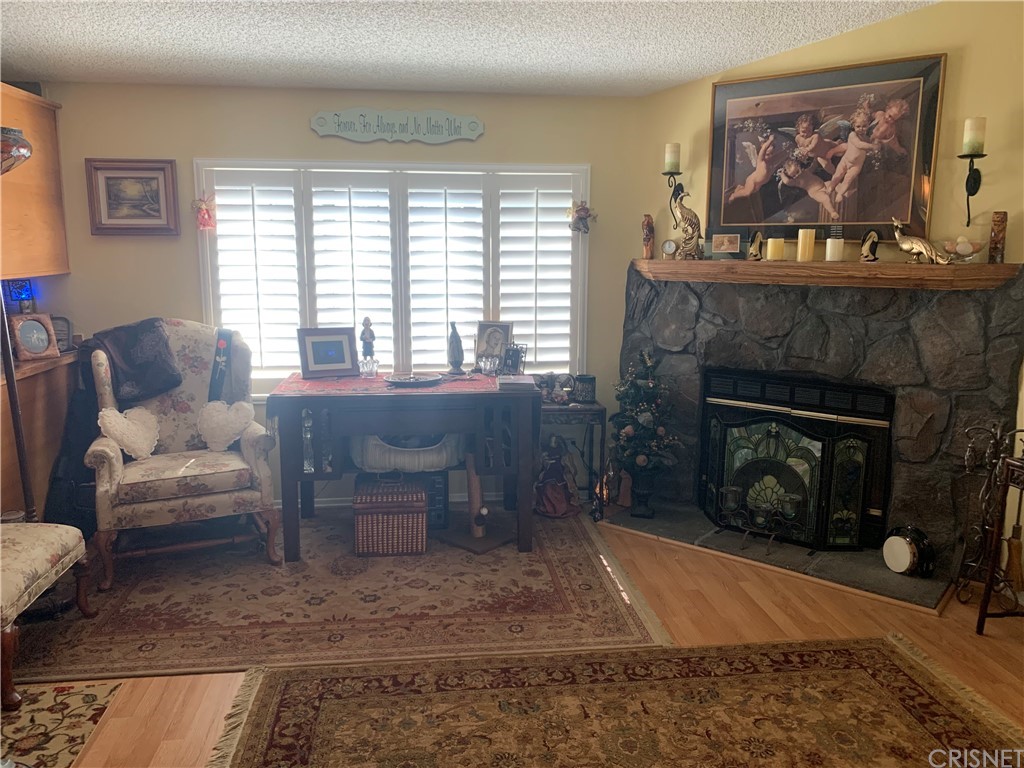 29043 Paradise Road Val Verde, CA 91384 - Photo 8 of 23 a living room with furniture and a fireplace