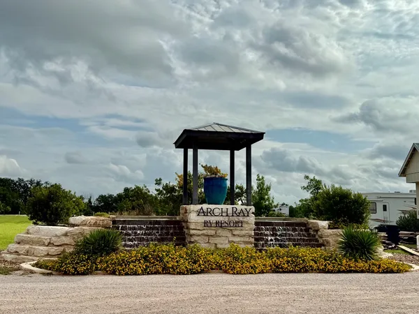 a view of a fountain in the backyard of a house