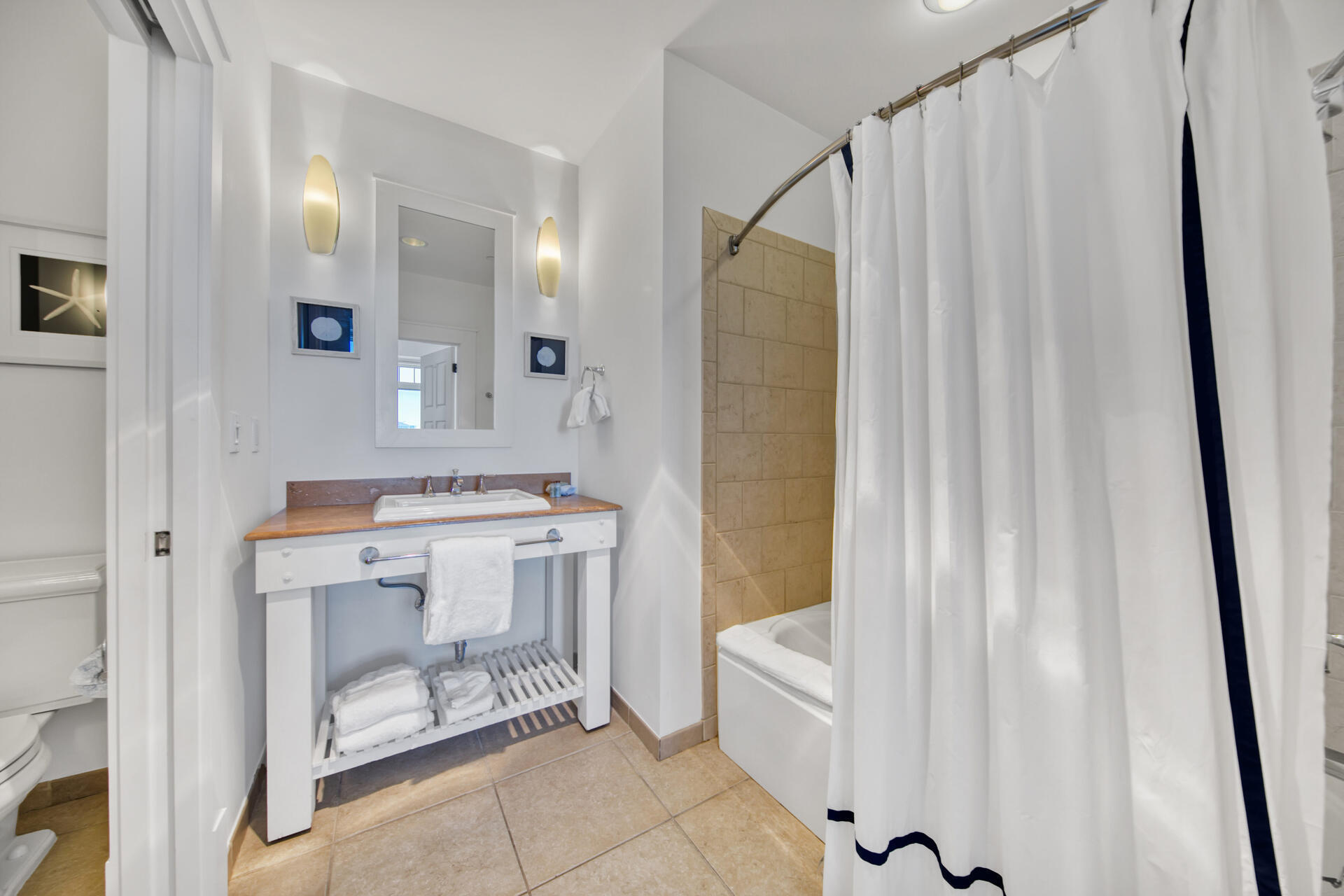 99 Compass Point Way South, Unit 404 Inlet Beach, FL 32461 - Photo 7 of 19 a bathroom with a sink mirror and a bathtub