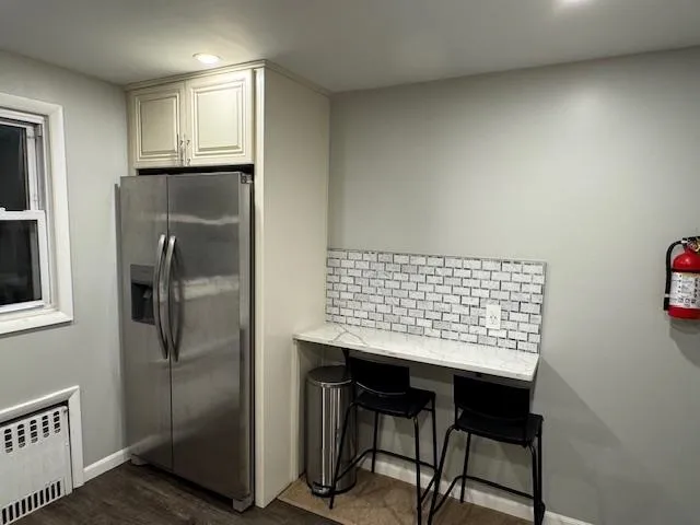 a kitchen with kitchen island a counter top space cabinets and stainless steel appliances
