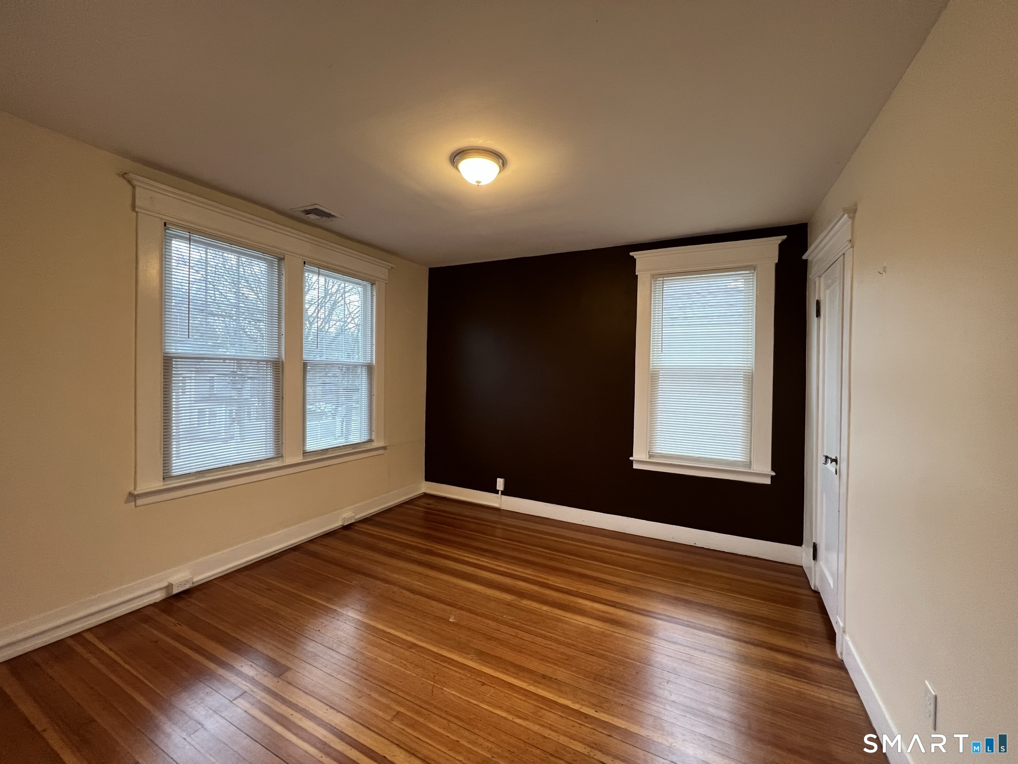 1546 Whitney Avenue Hamden, CT 06517 - Photo 11 of 21 a view of an empty room with wooden floor and a window