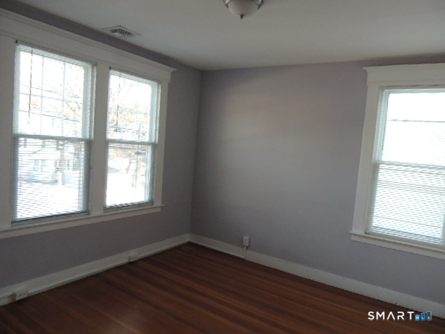 1546 Whitney Avenue Hamden, CT 06517 - Photo 19 of 21 a view of an empty room with wooden floor and a window