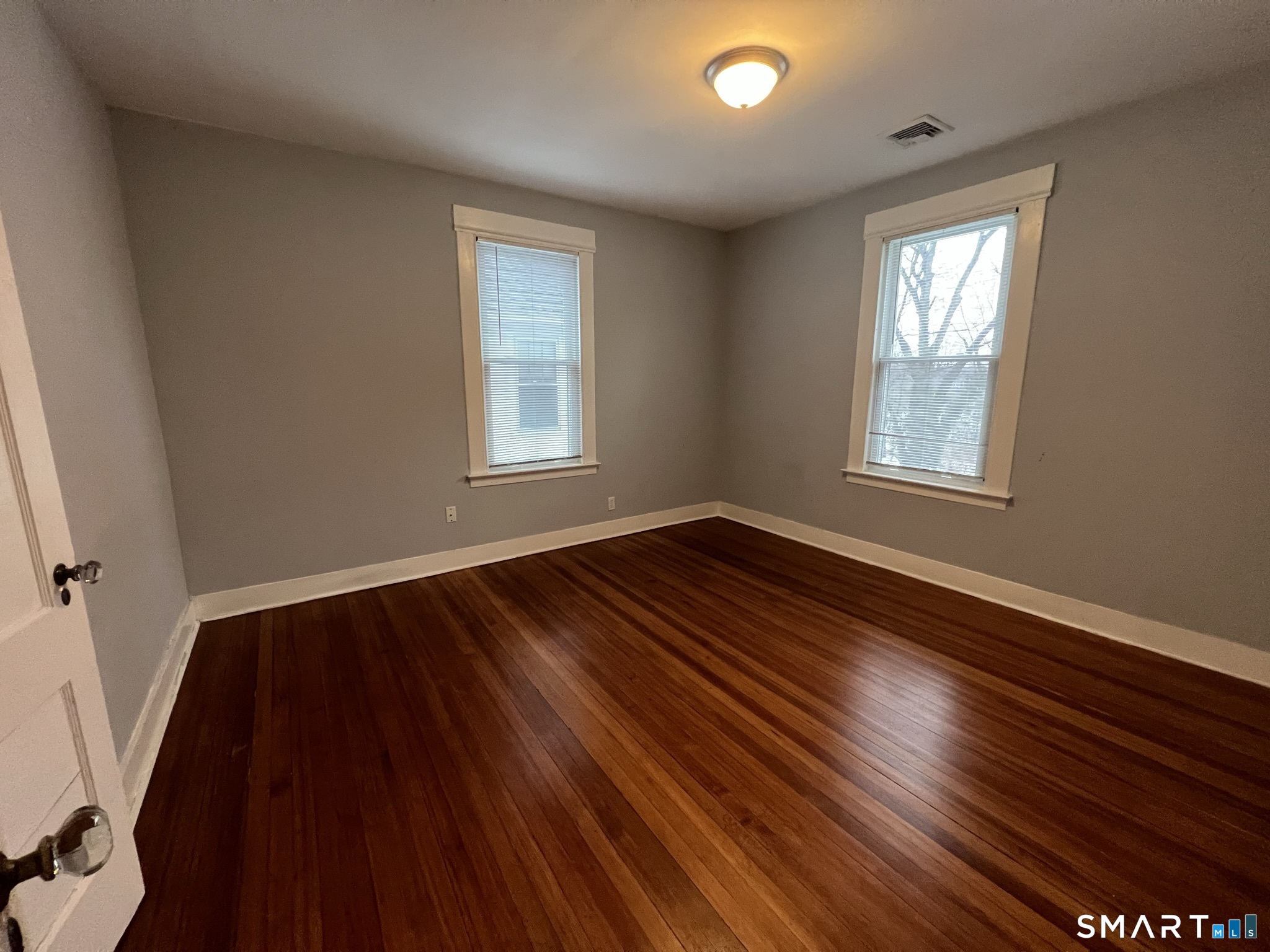 1546 Whitney Avenue Hamden, CT 06517 - Photo 8 of 21 a view of an empty room with wooden floor and a window