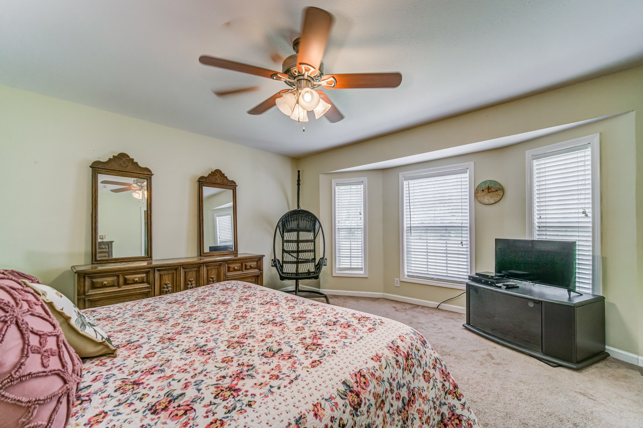 5407 Marion Road Cunningham, TN 37052 - Photo 12 of 35 a bedroom with a bed a ceiling fan and a flat screen tv