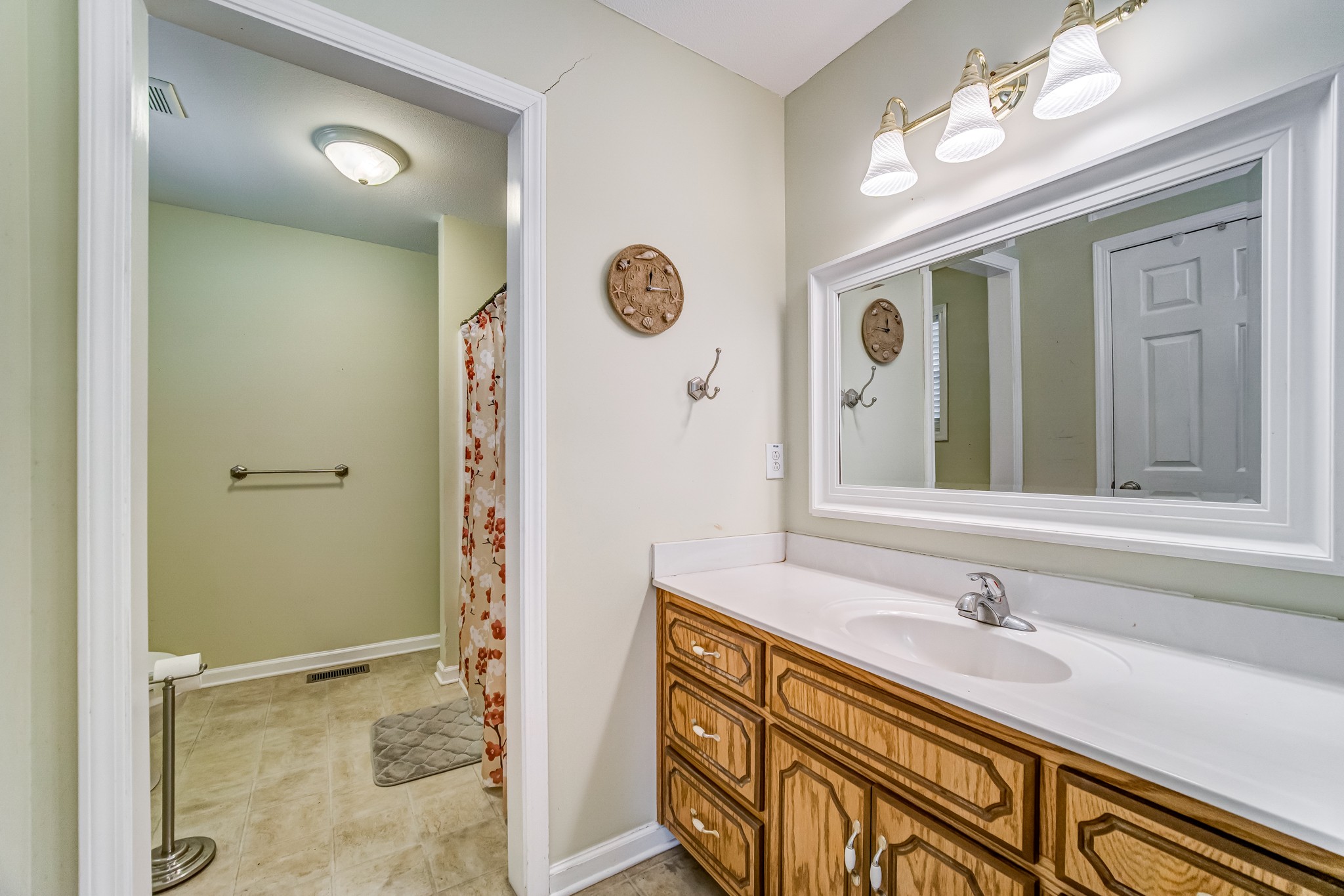 5407 Marion Road Cunningham, TN 37052 - Photo 15 of 35 a bathroom with a sink a mirror and a shower