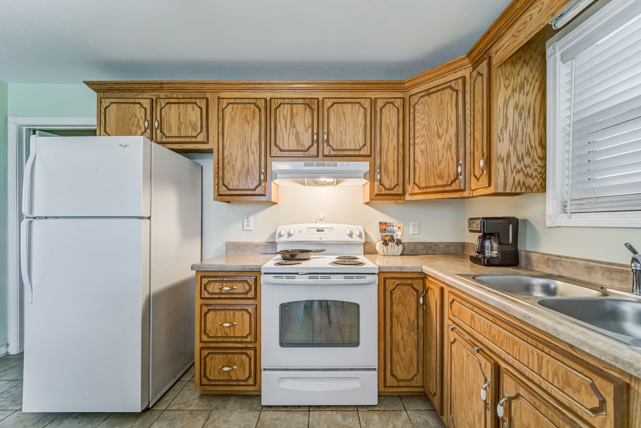 5407 Marion Road Cunningham, TN 37052 - Photo 21 of 35 a kitchen with stainless steel appliances granite countertop a refrigerator a stove and a sink with cabinets