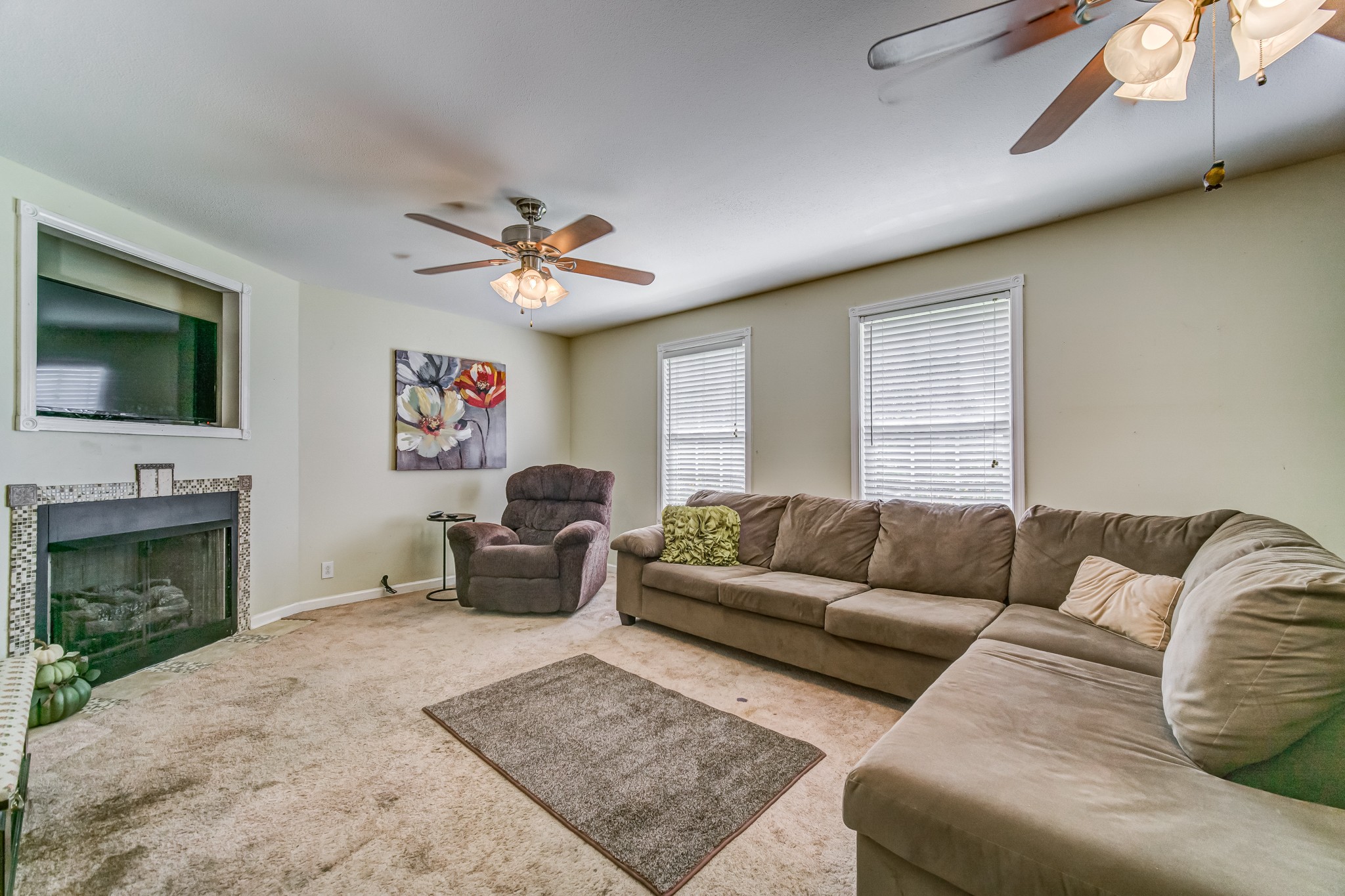 5407 Marion Road Cunningham, TN 37052 - Photo 4 of 35 a living room with furniture a fireplace and a flat screen tv