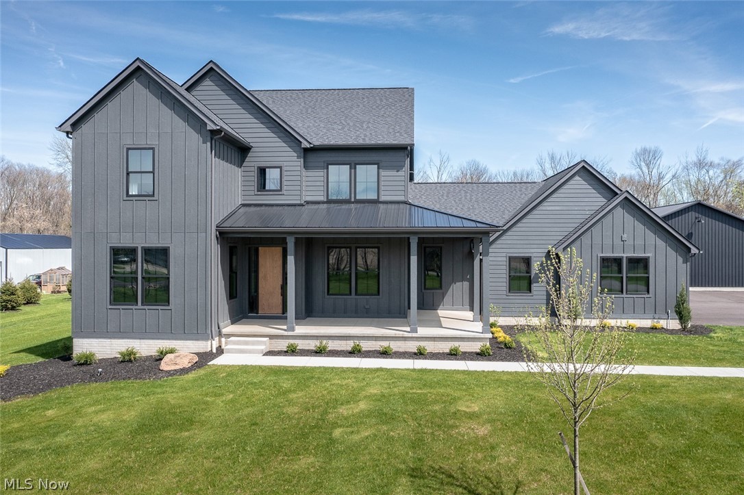 4197 Beach Road Medina, OH 44256 - Photo 3 of 35 Modern farmhouse style home with covered porch and a front lawn