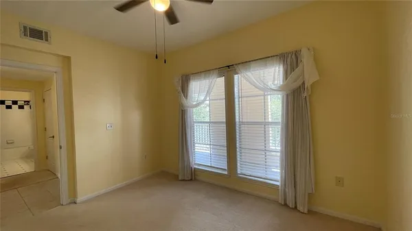 a view of empty room with fireplace and chandelier fan