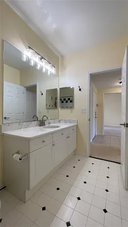 a spacious bathroom with a double vanity sink and a mirror
