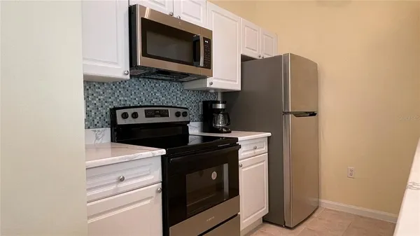 a kitchen with a stove microwave and refrigerator