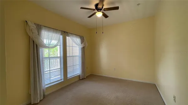 a view of empty room with ceiling fan