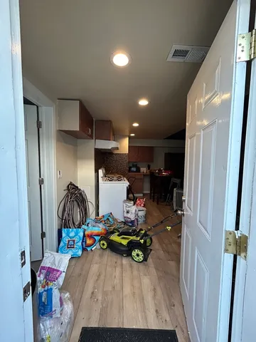a living room with furniture a chandelier and a window