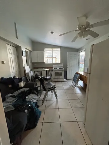 a bed sitting in a spacious bedroom next to a window