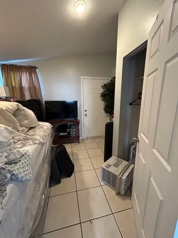 a bedroom with a bed and a television