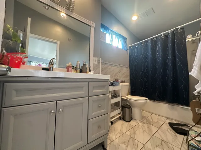 a bathroom with a toilet sink and mirror