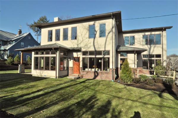 5 Kennard Road Brookline, MA 02445 - Photo 1 of 14 a front view of a house with a yard table and chairs
