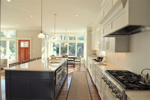 5 Kennard Road Brookline, MA 02445 - Photo 5 of 14 a large kitchen with stainless steel appliances granite countertop a sink and a stove