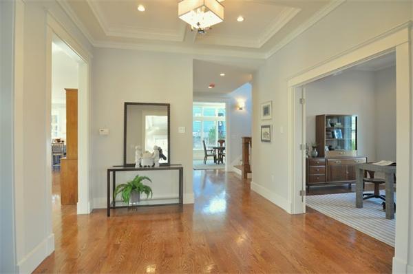 5 Kennard Road Brookline, MA 02445 - Photo 9 of 14 a view of a hallway with wooden floor and a chandelier