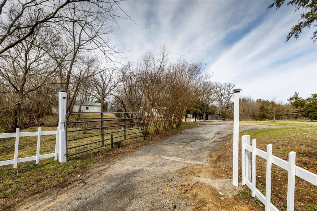 1751 Whitney Road Sherman, TX 75090 - Photo 1 of 1 View of road with driveway and a gate