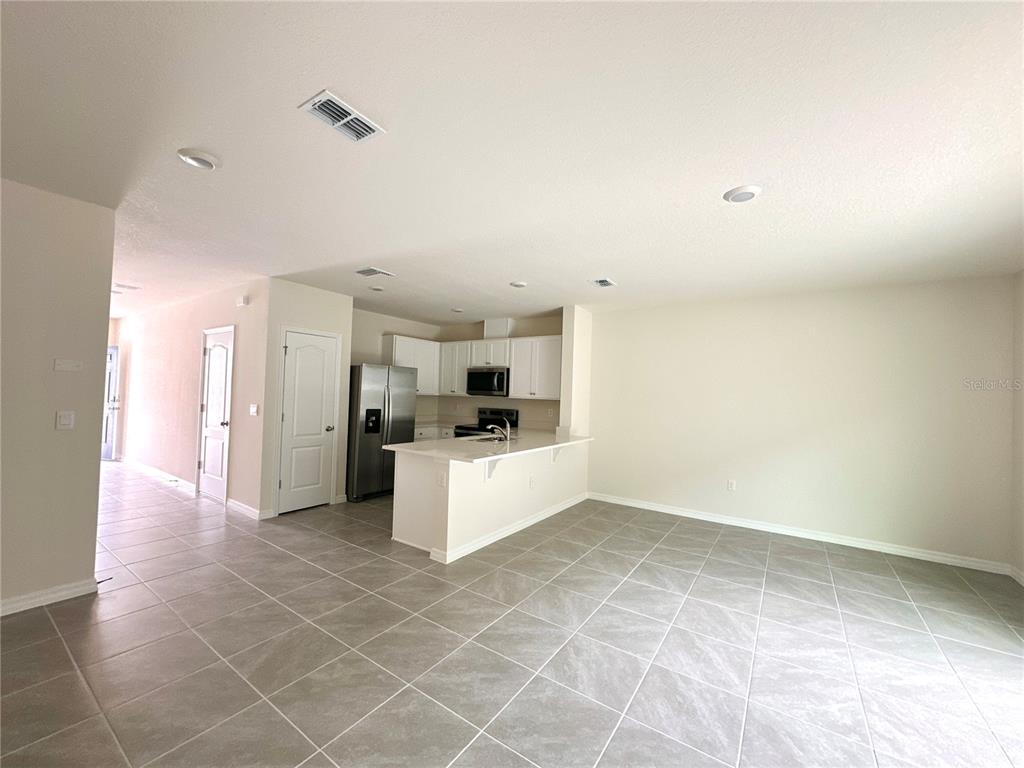 2742 Puffin Place Davenport, FL 33837 - Photo 13 of 31 a view of kitchen with refrigerator cabinets and window