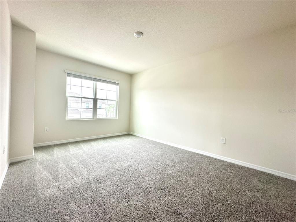2742 Puffin Place Davenport, FL 33837 - Photo 19 of 31 an empty room with windows