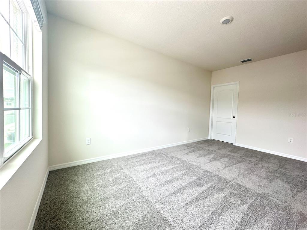 2742 Puffin Place Davenport, FL 33837 - Photo 20 of 31 an empty room with a window