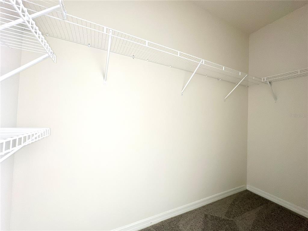 2742 Puffin Place Davenport, FL 33837 - Photo 22 of 31 a view of a room with racks on the wall