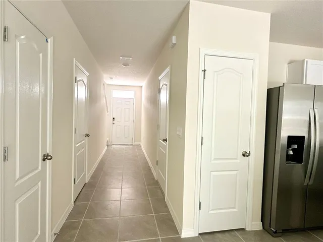 a kitchen with granite countertop a refrigerator and a stove top oven