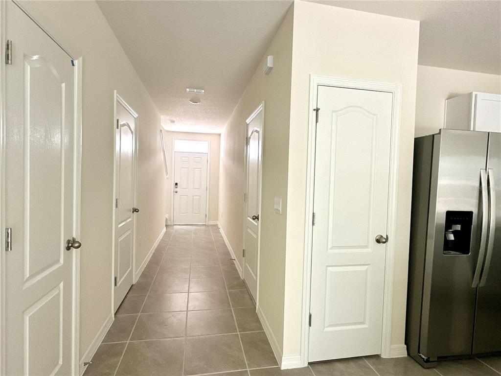 2742 Puffin Place Davenport, FL 33837 - Photo 5 of 31 a view of a hallway with wooden floor