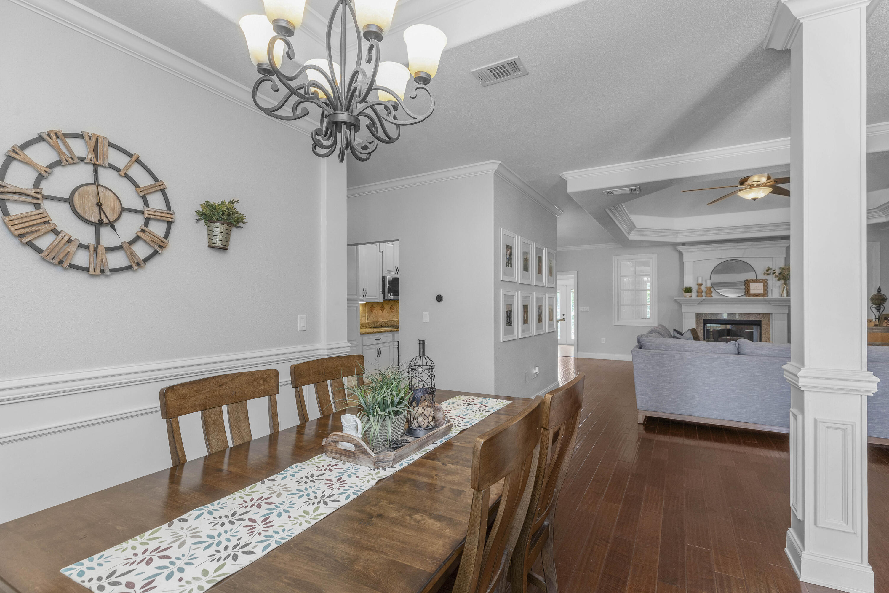 2946 Chantry Circle Crestview, FL 32539 - Photo 15 of 55 a view of a dining room with furniture a chandelier and wooden floor