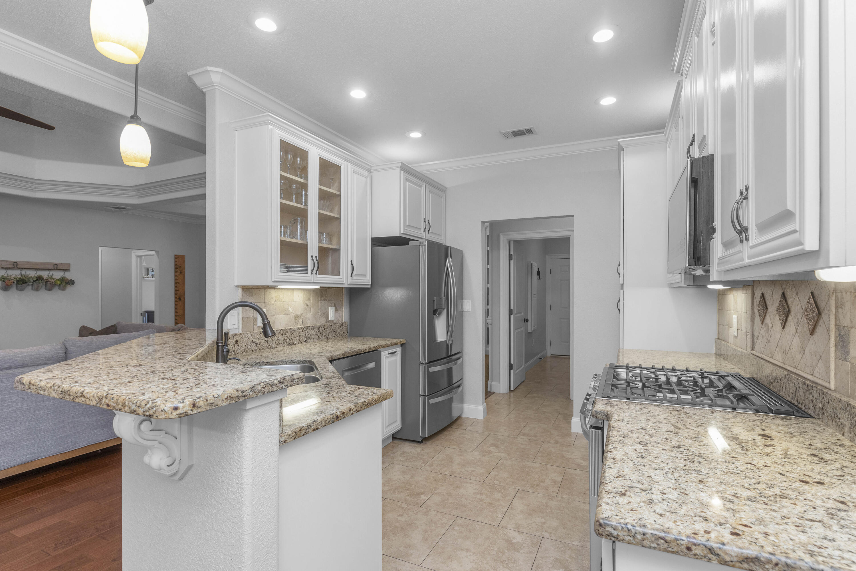 2946 Chantry Circle Crestview, FL 32539 - Photo 19 of 55 a kitchen with stainless steel appliances granite countertop a sink and a refrigerator