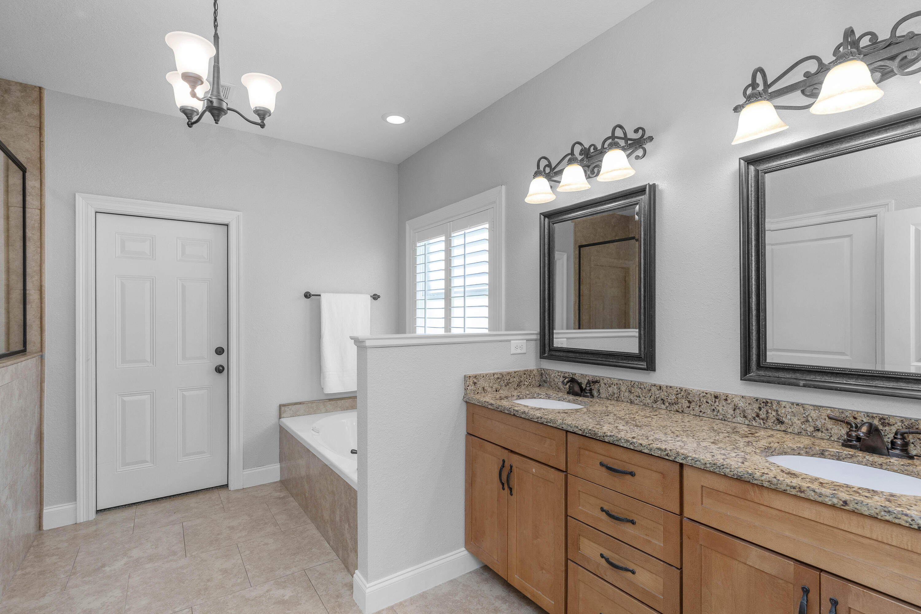 2946 Chantry Circle Crestview, FL 32539 - Photo 31 of 55 a bathroom with double vanity sinks a vanity a lamp and a mirror