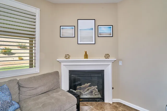 a kitchen with stainless steel appliances granite countertop table chairs sink refrigerator and cabinets