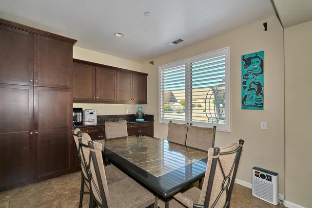 a kitchen with kitchen island granite countertop a sink stove and refrigerator