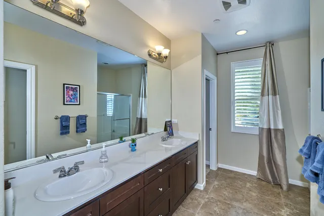 a bathroom with a tub shower and sink