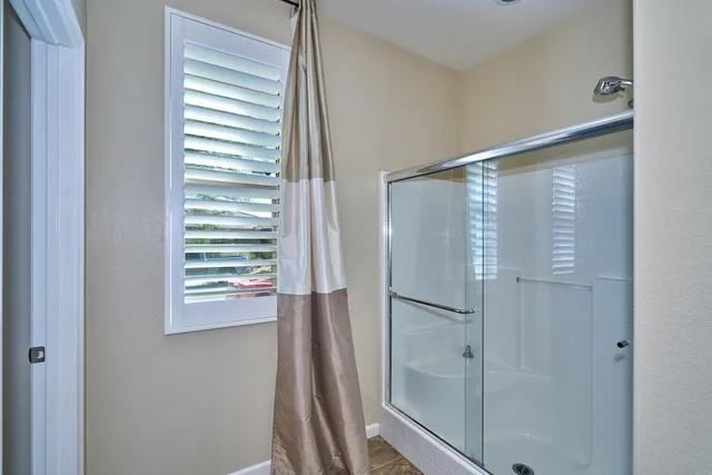 a en suite bathroom with double vanity and a mirror