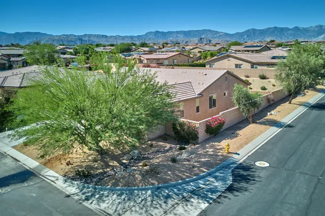 an aerial view of residential houses with outdoor space and street view