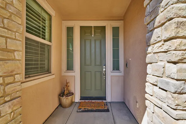 a living room with furniture a table and a large window